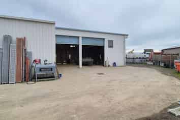 Workshop with gantry, warehouse, and secure yard.