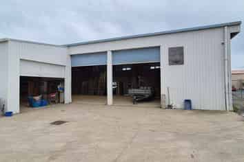 Workshop with gantry, warehouse, and secure yard.