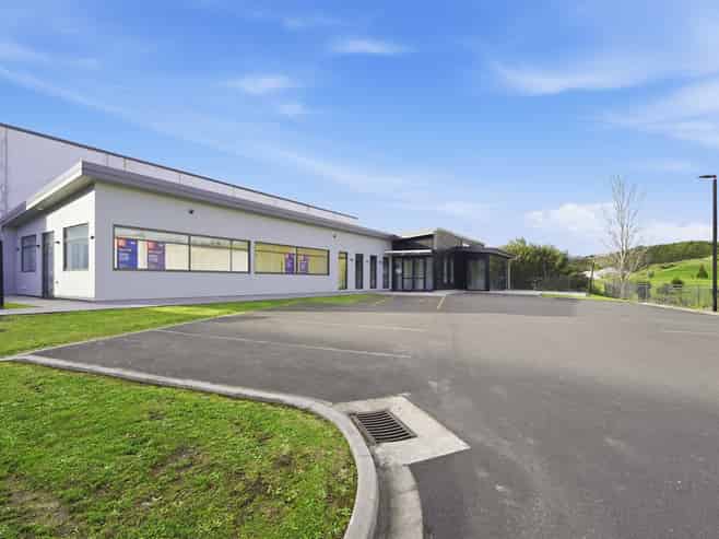 Tauriko building with 15 carparks
